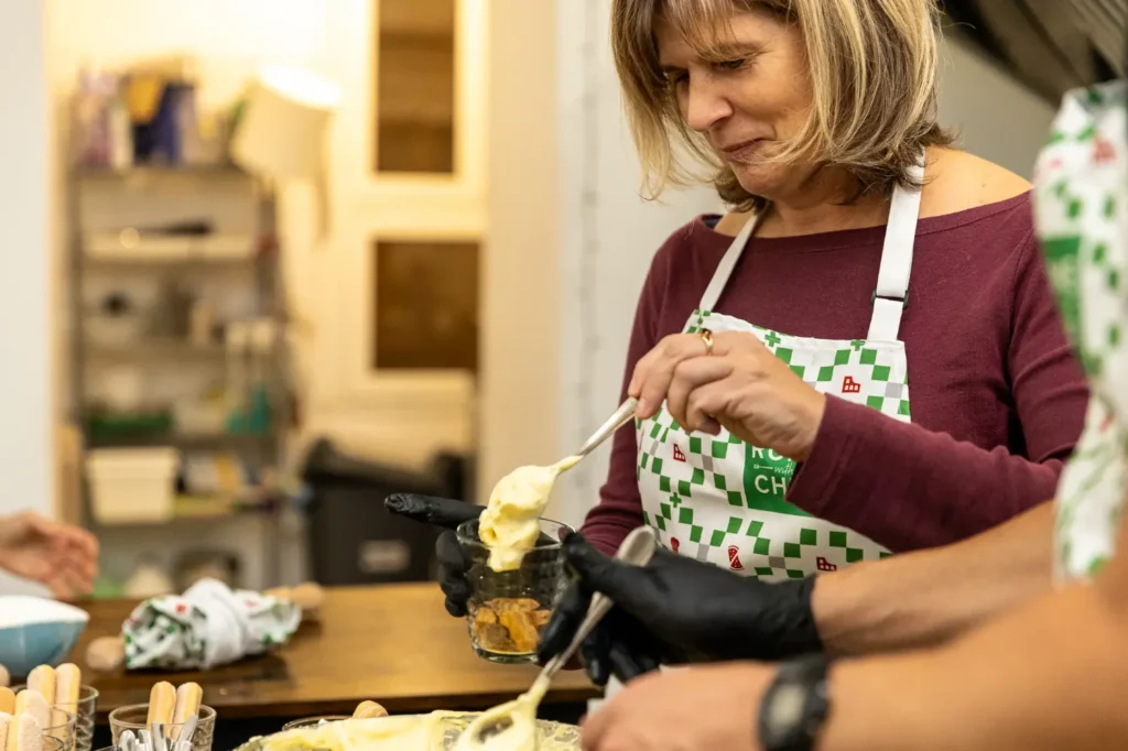 Woman enjoying fresh herbs and food during Pizza & Tiramisu Class experience
