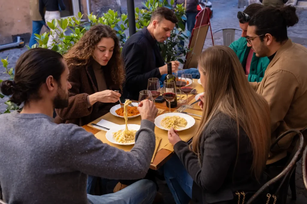 Small group enjoying plates of authentic Roman pasta on a Rome Food Tour