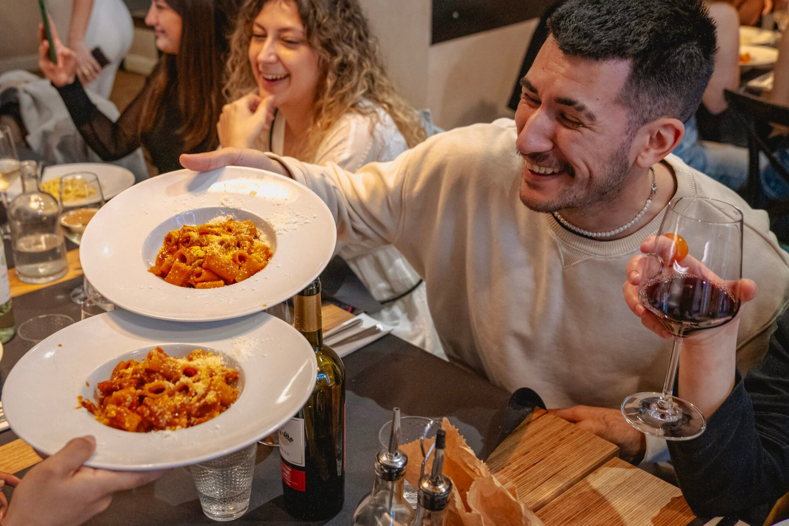 Guy holding up a plate of Rigatoni all'Amatriciana on a Rome Food Tour