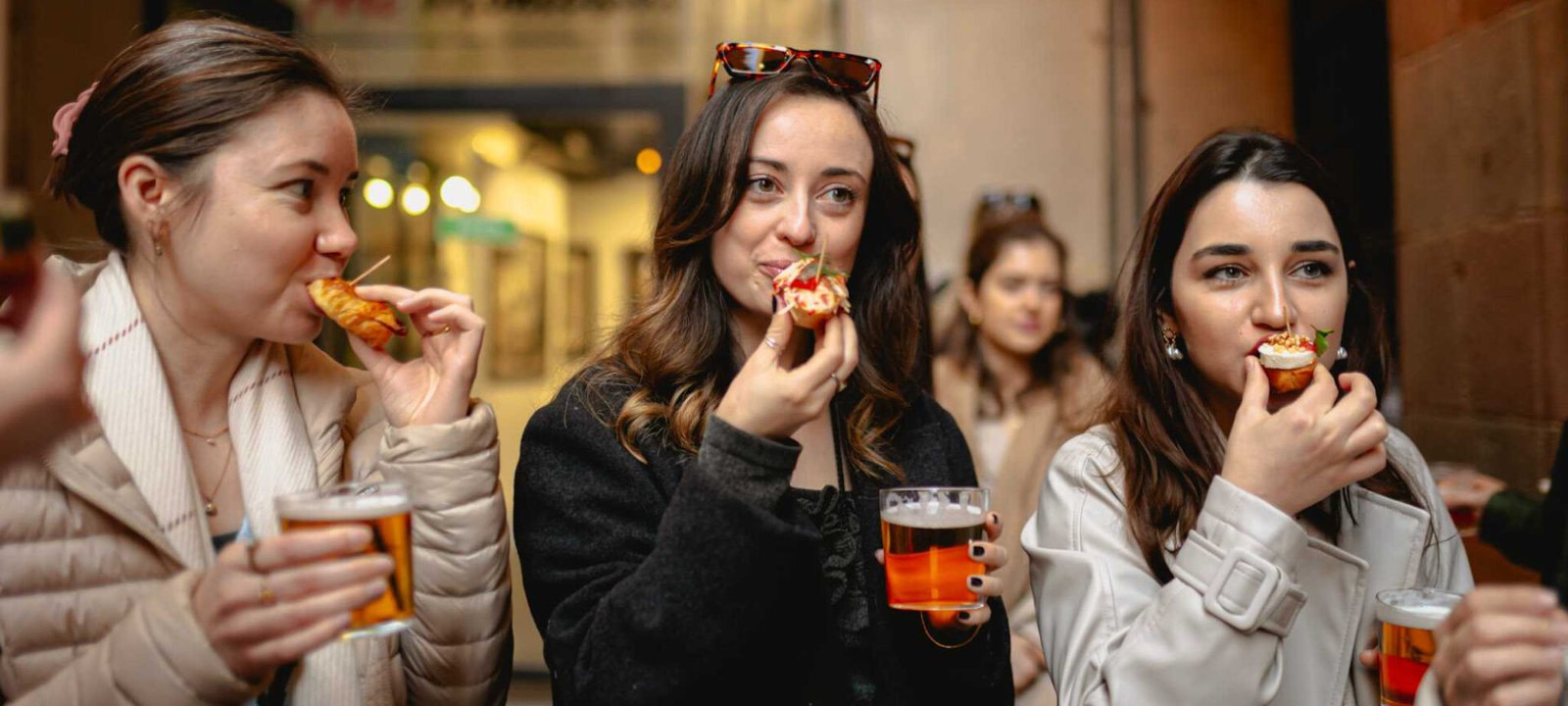 Young women enjoying tapas and sangria on a Barcelona Tipsy Tapas Food Crawl