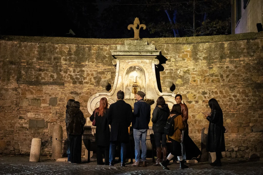 Tourists gathered around an ancient, dimly lit fountain in Rome to hear a ghost story.