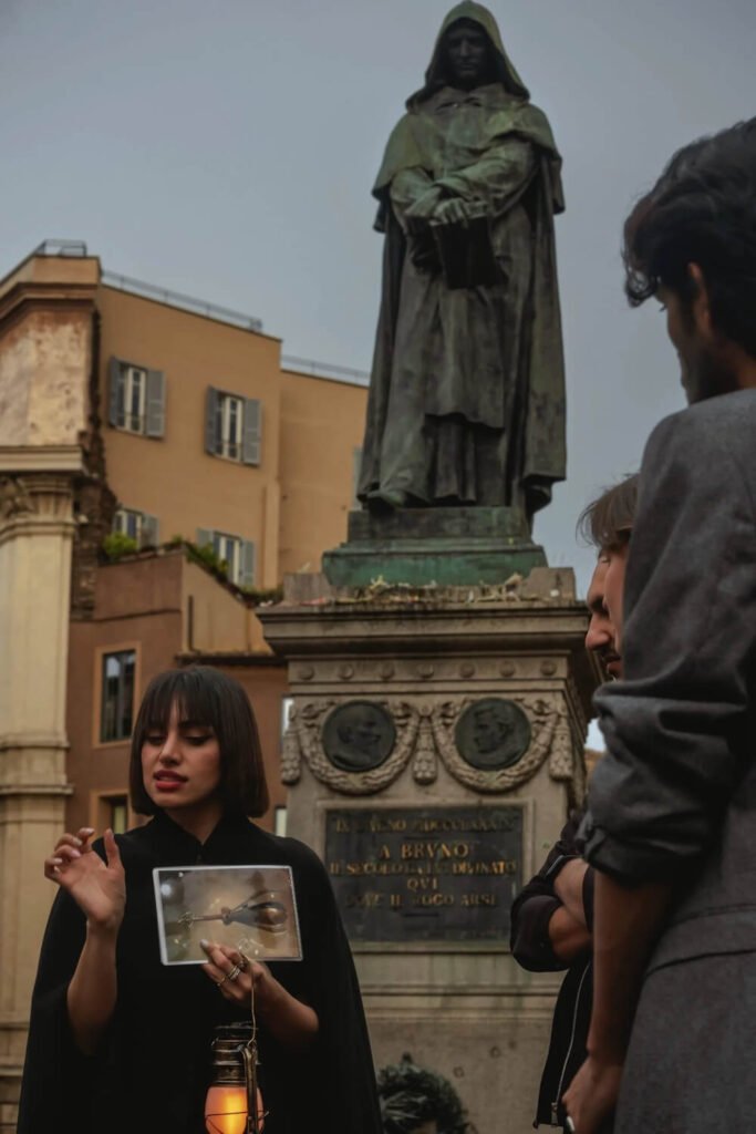 Tipsy Tour guide beneath the statue of Giordano Bruno Rome's Campo de' Fiori on a Rome Ghost Tour