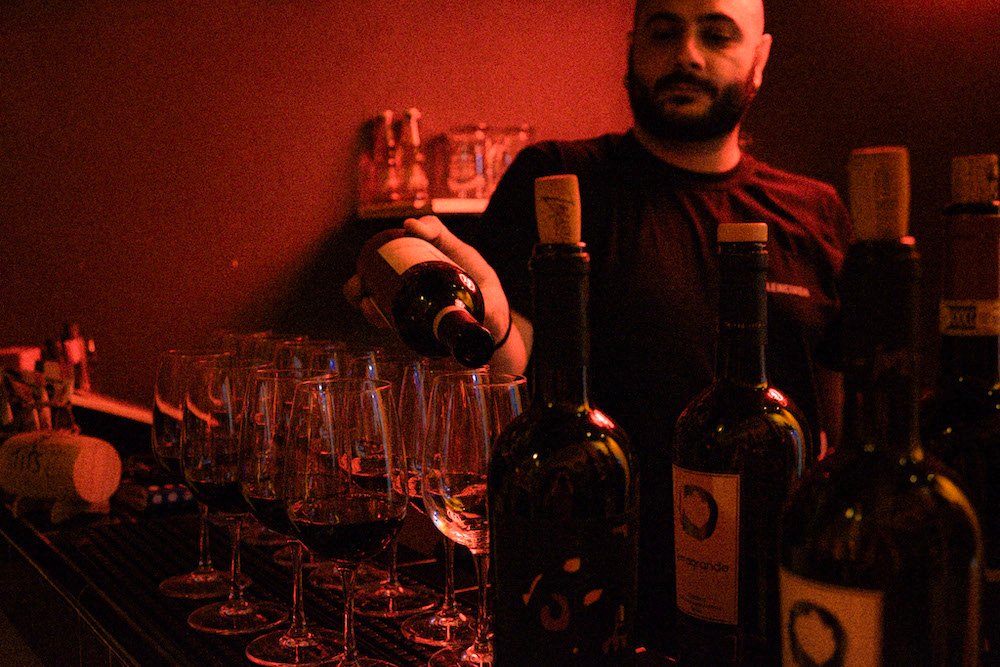 Pouring wine at Vino e Vinili in Rome