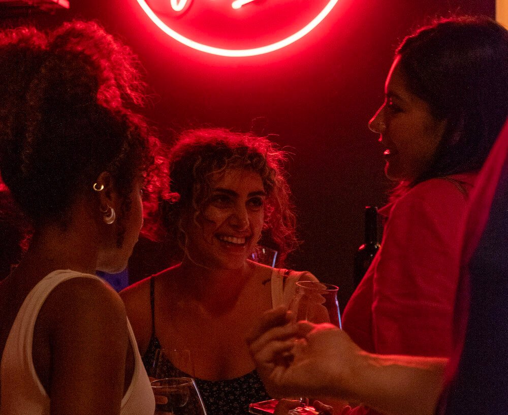 Young women enjoying a drink at Vino e Vinili, one of the best wine bars in Rome