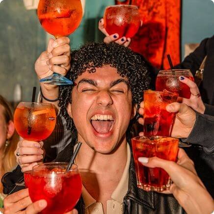 Bachelor surrounded by Campari spritz